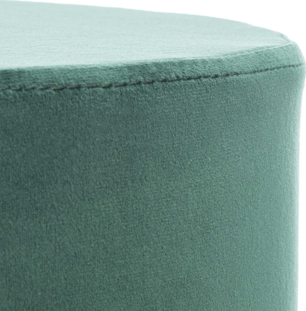 Fine stitching follows the curve of a softly textured green velvet seat