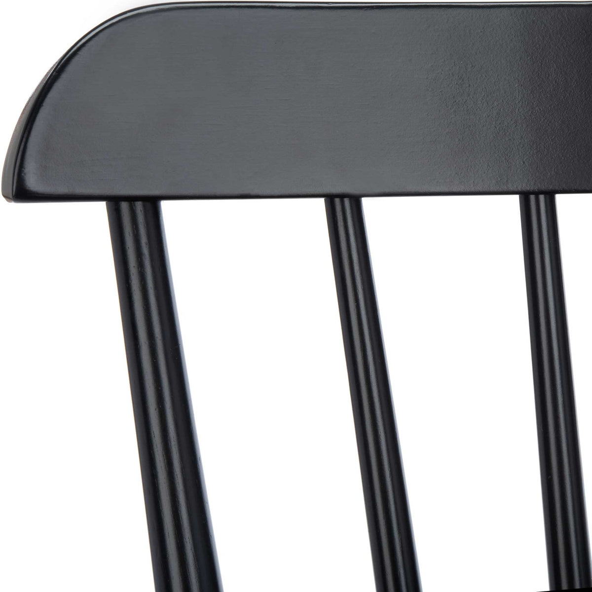 Sleek black curved back rail is joined to slim wood spindles.