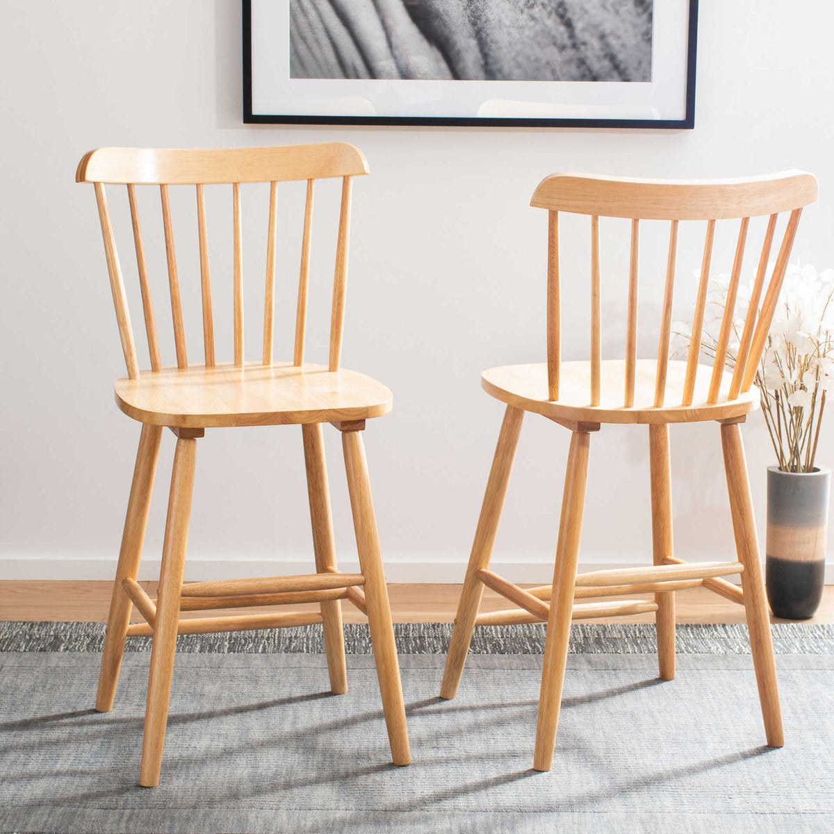 Two natural wood counter stools warm up the room with airy spindle backs and light grain.