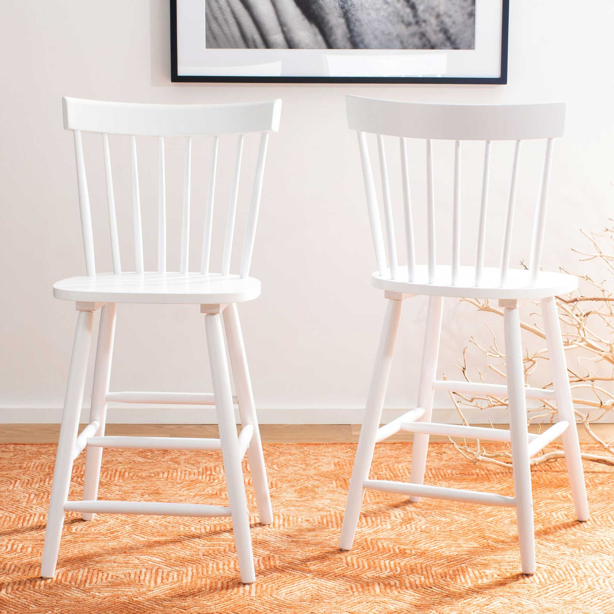 Two white counter stools brighten the room with spindle backs and crisp, braced frames.