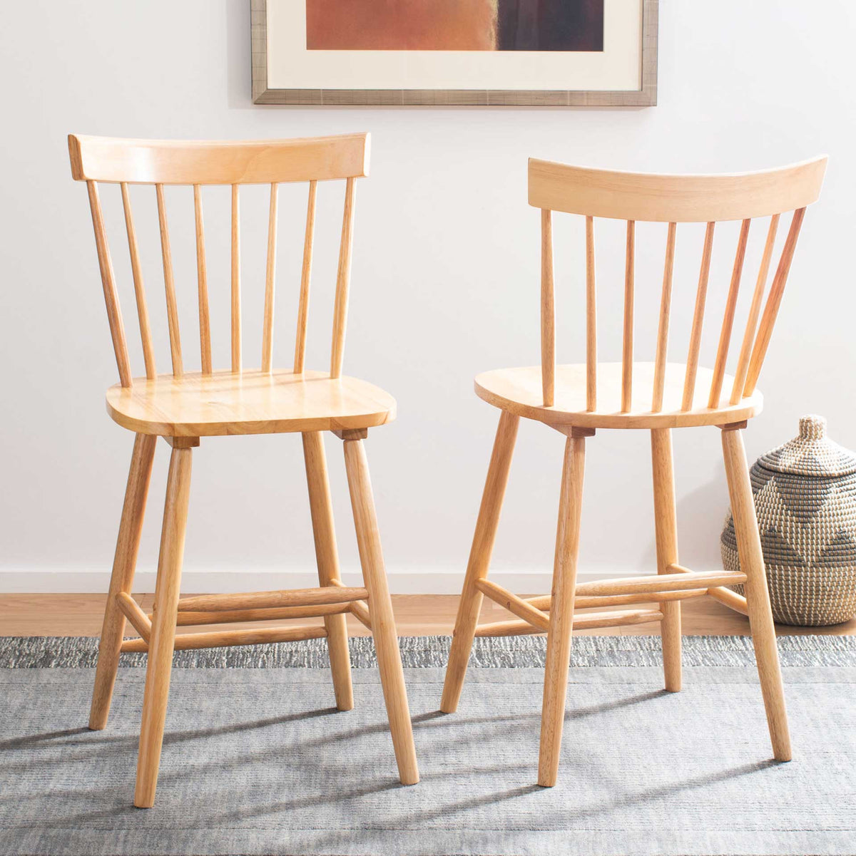 Two natural wood counter stools add light, inviting spindle-back seating to a cozy room.