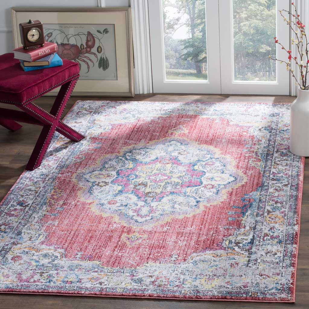 A distressed rose field and intricate floral medallion bring warmth to a bright living space