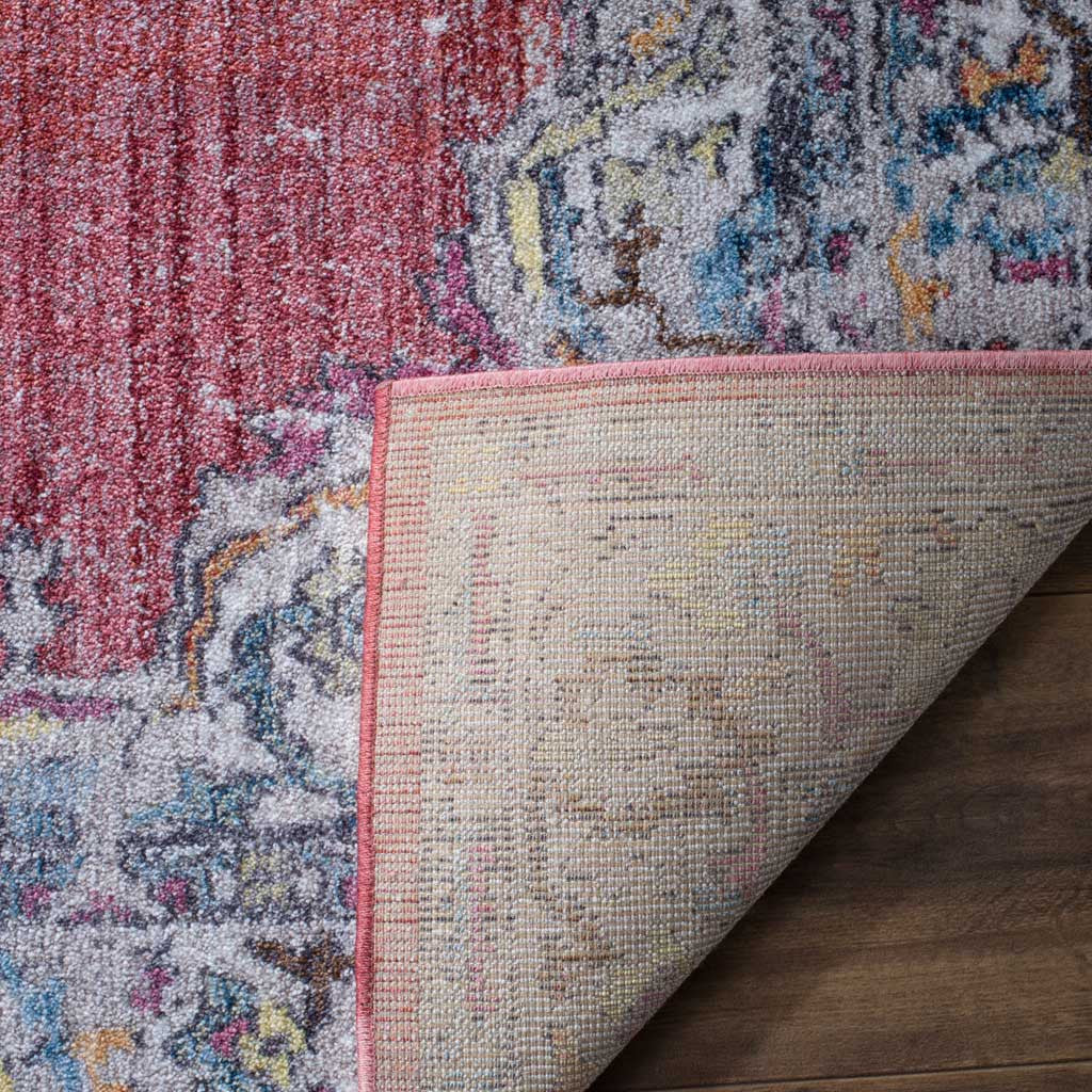 Woven jute backing supports the rug's rose and light gray floral pile