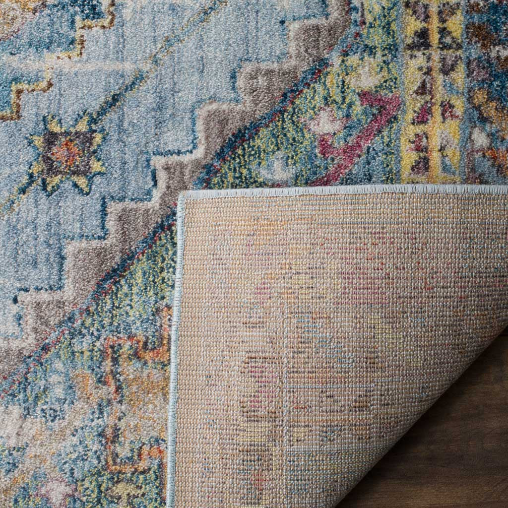 A folded edge reveals woven jute backing beneath the colorful patterned pile