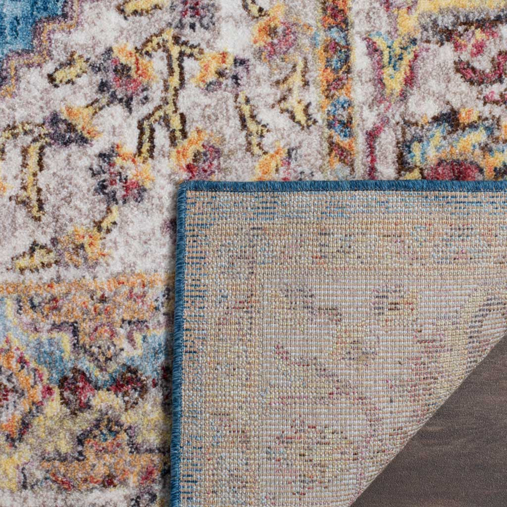 A sturdy beige jute backing supports the patterned pile and neatly bound blue edge.