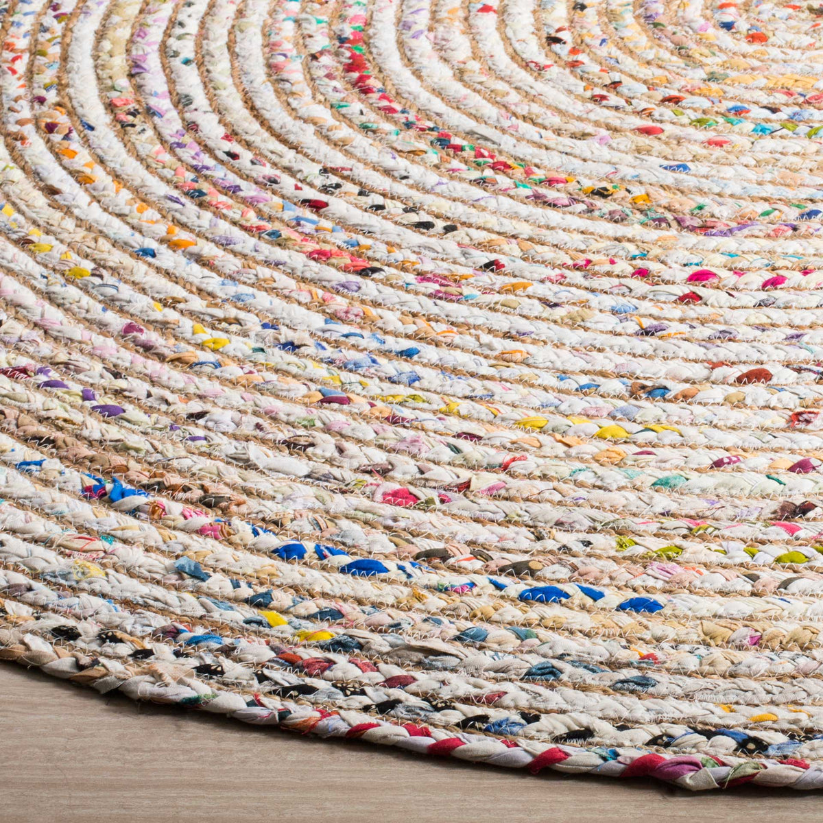 Colorful cotton and jute braids add tactile depth to this round rug's finished edge.