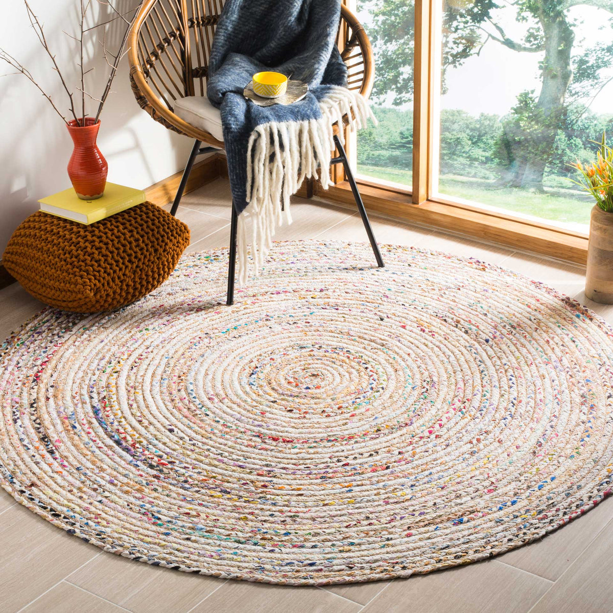 Warm beige spirals and playful color flecks lend relaxed charm to this round rug.