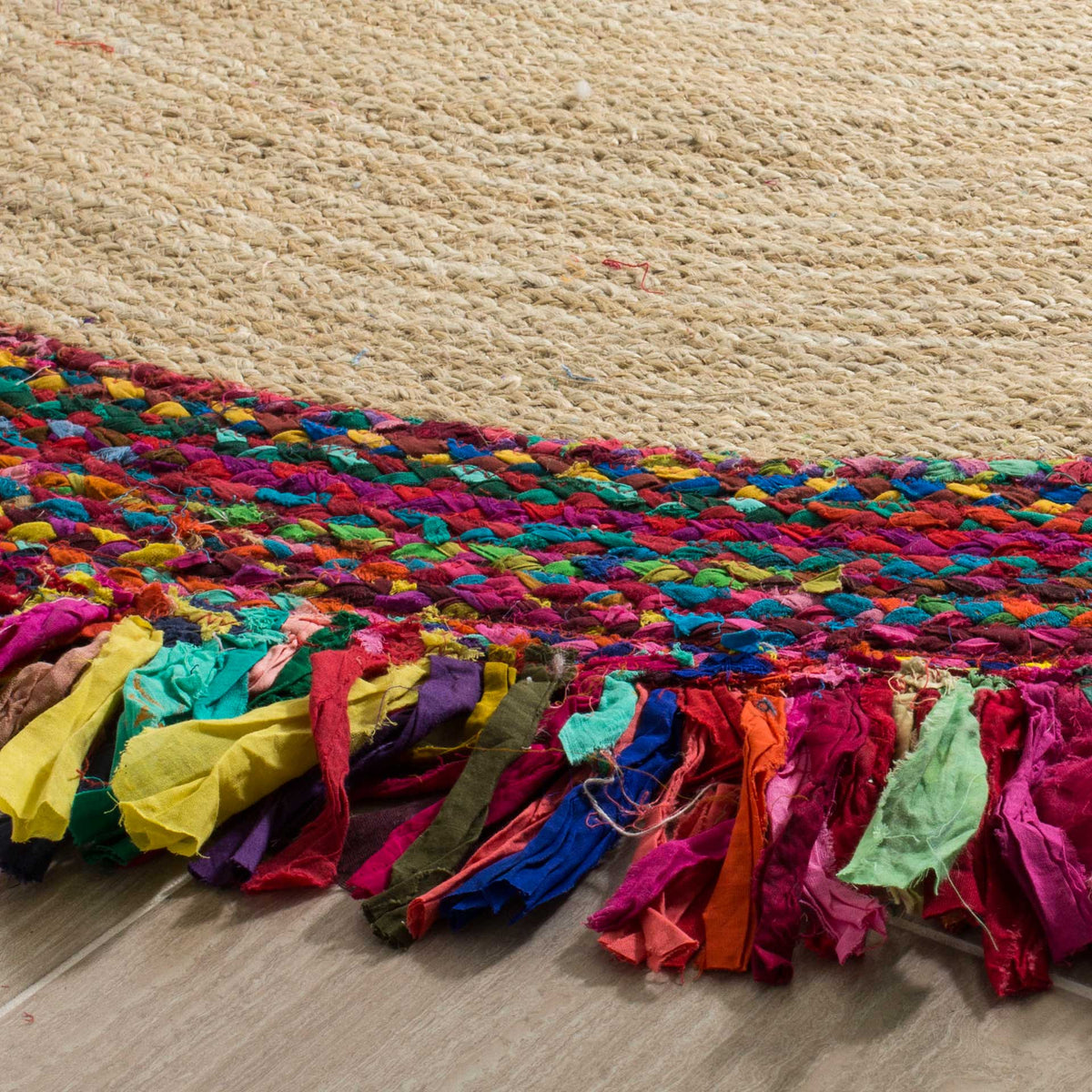 Natural jute meets jewel-toned braids and colorful fabric fringe along this rug's edge.