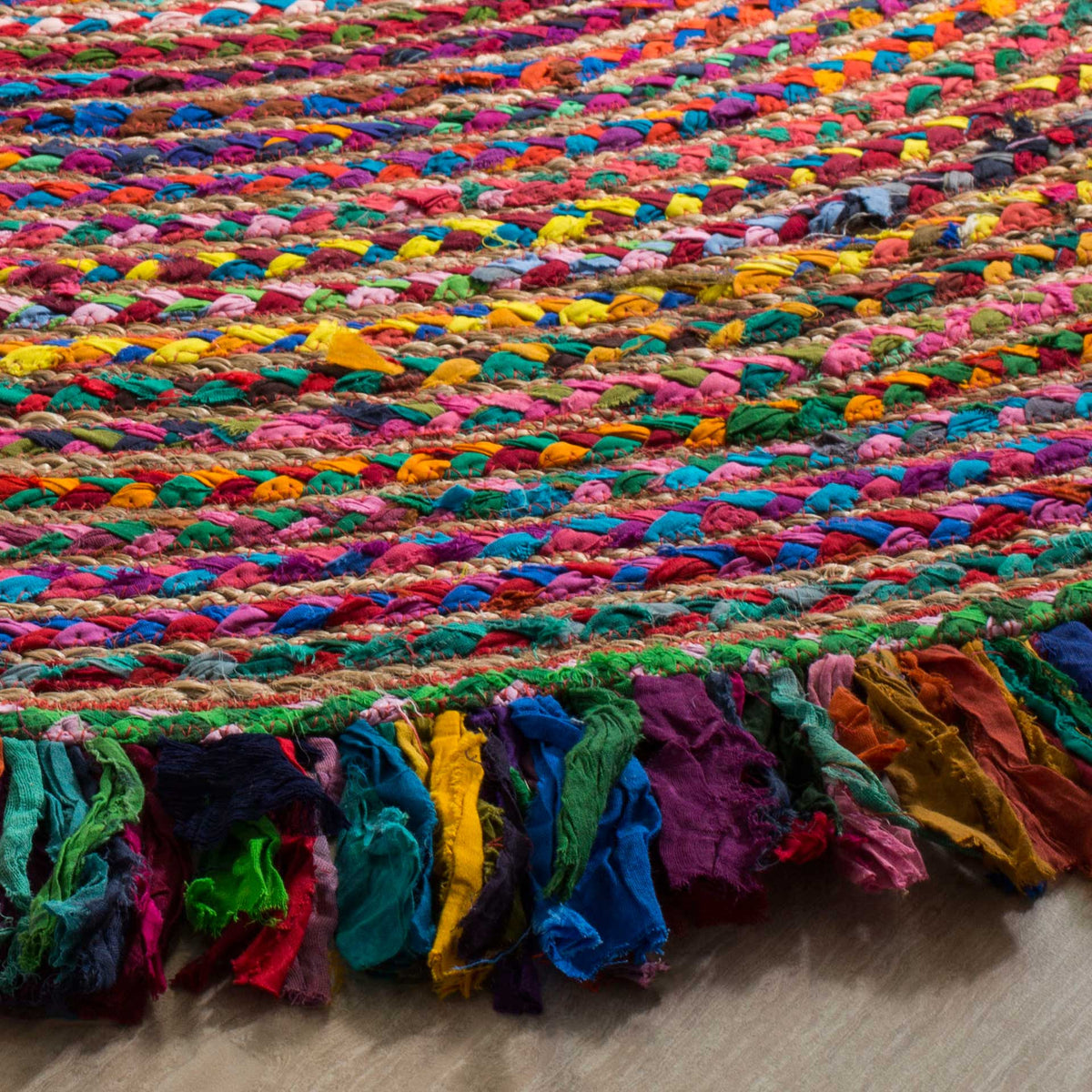 Chunky, colorful braids meet a lively fabric fringe at the edge of this round rug.