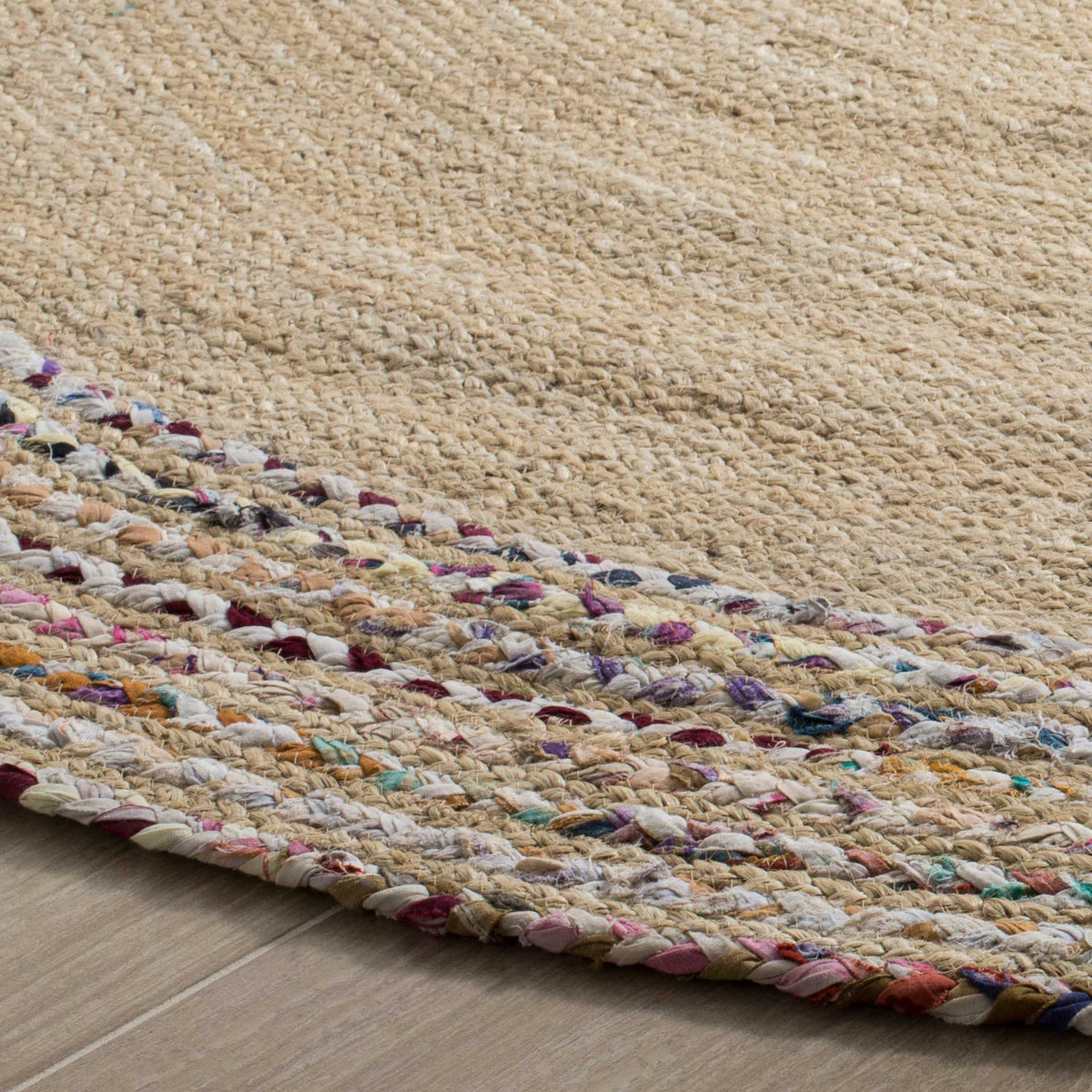Natural jute coils transition into a softly speckled border with a tidy bound edge.