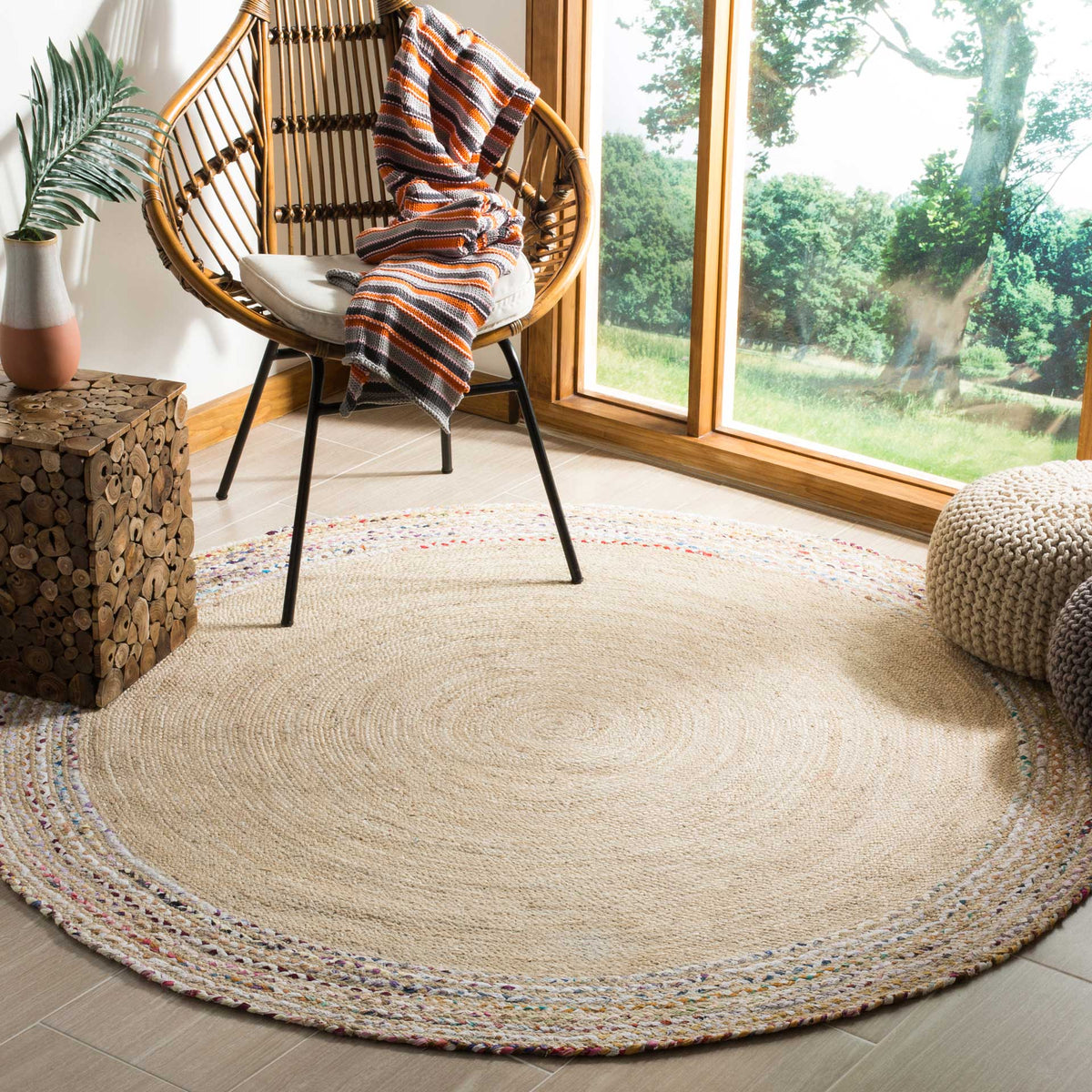 Natural jute and a lightly colorful border add laid-back warmth to this round rug.