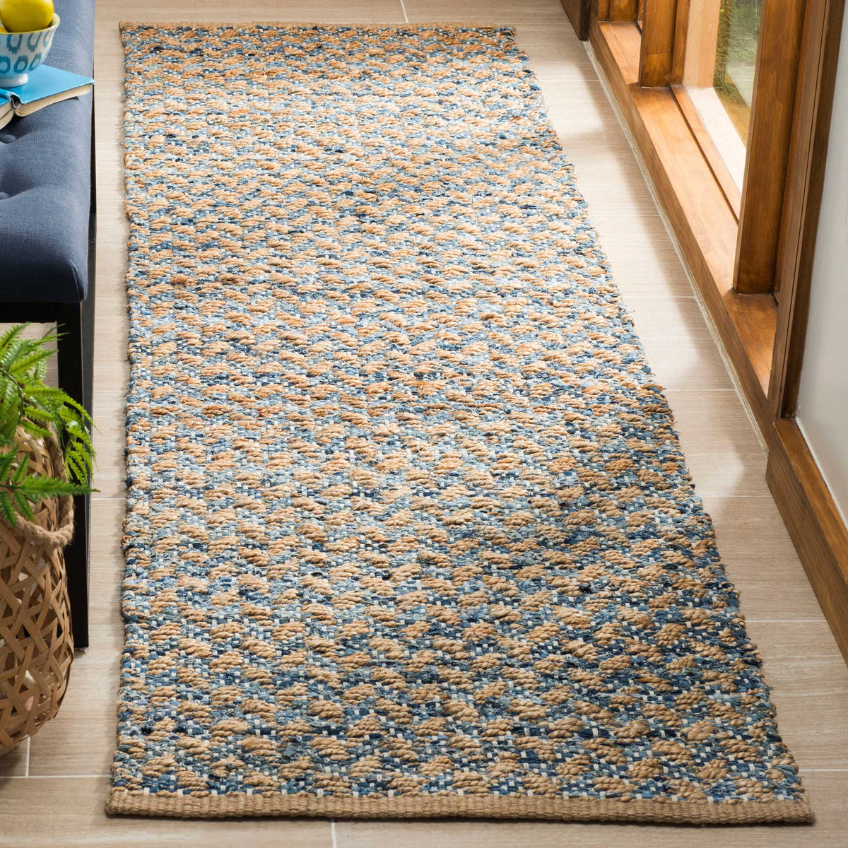 Handwoven blue accents ripple across natural fibers for a relaxed, welcoming runner