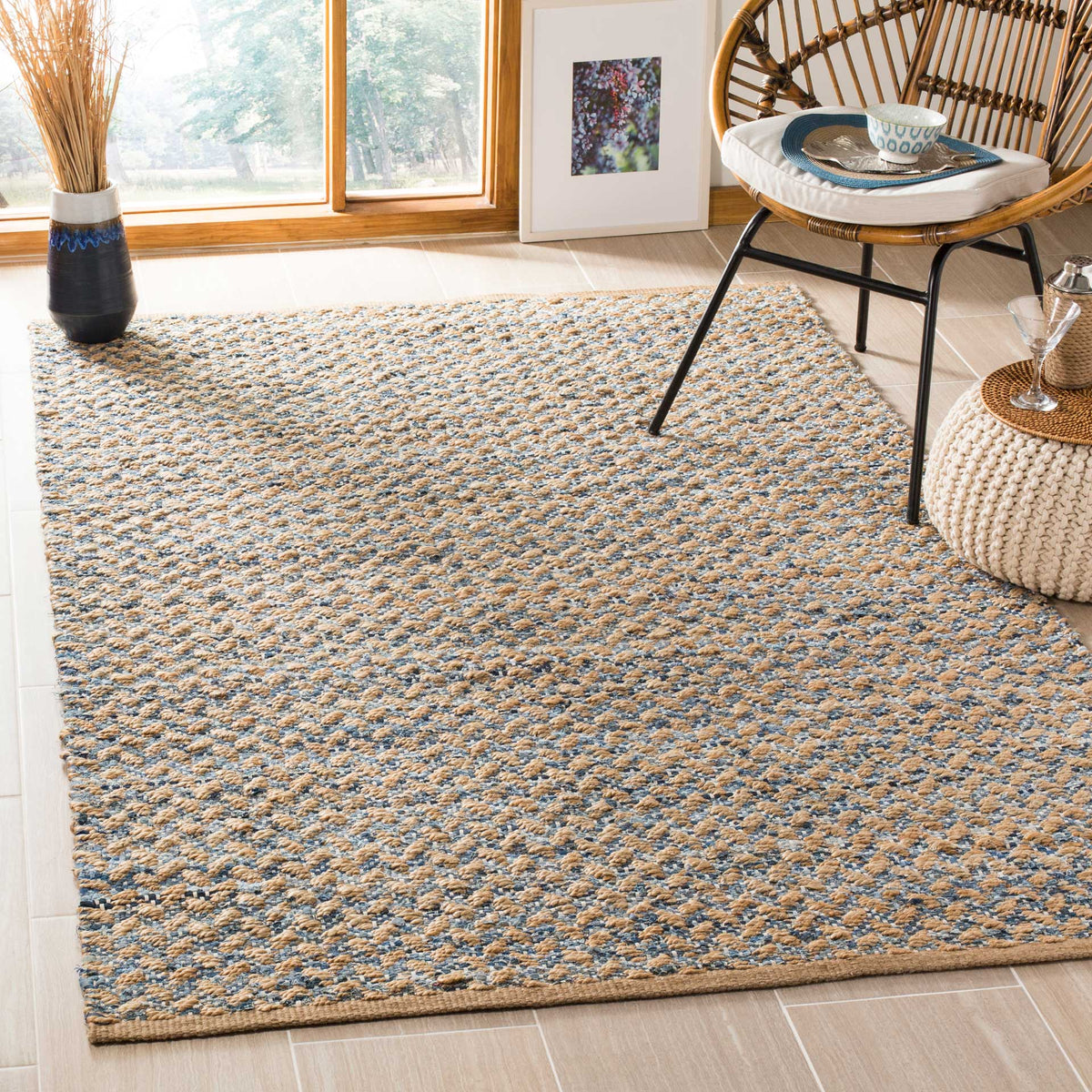 Natural and blue jute rug adds rustic texture beneath an accent chair