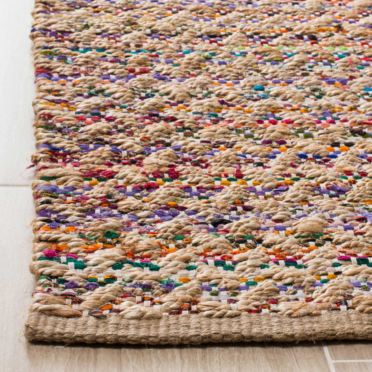 Raised tan jute knots interlace with bright fabric flecks at the finished edge