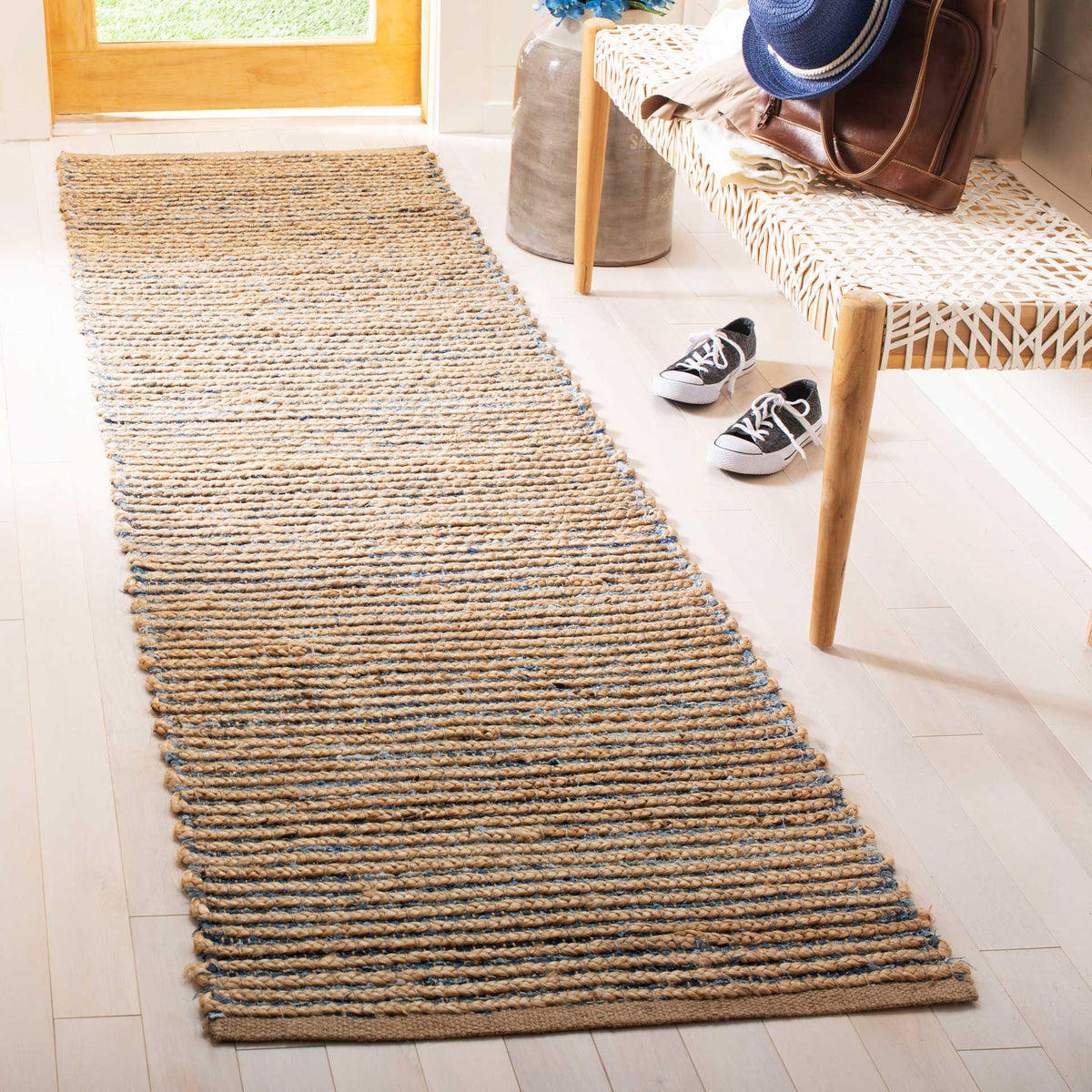 Cool blue lines punctuate warm jute braids across this earthy hallway runner