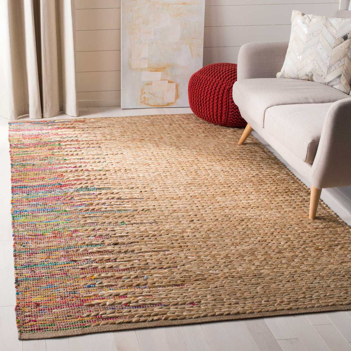 Bright multicolor accents along one side energize a natural jute rug