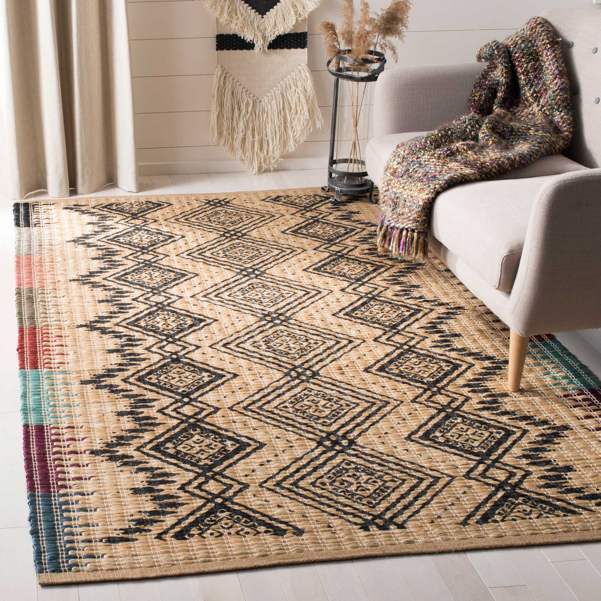 Black diamond patterns and jewel-toned side accents enliven a natural rug