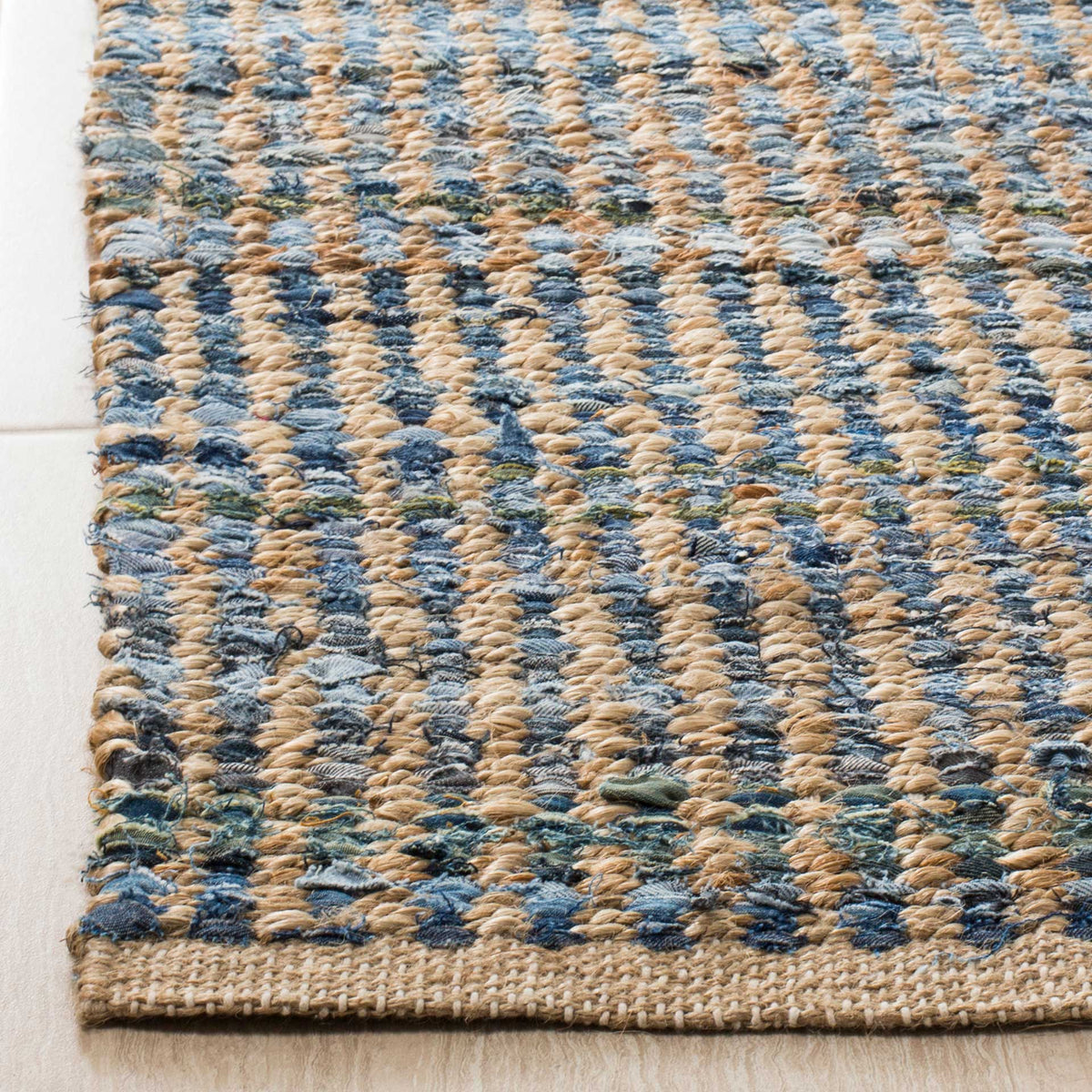 Blue denim strips and chunky tan jute knots meet at a sturdy bound edge