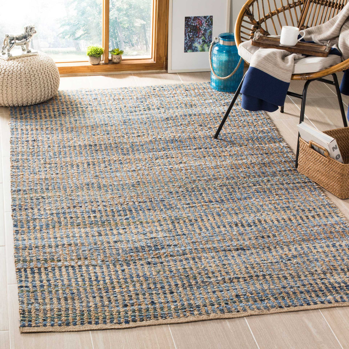 Blue and natural textured rug adds a calm woven base beneath a lounge chair