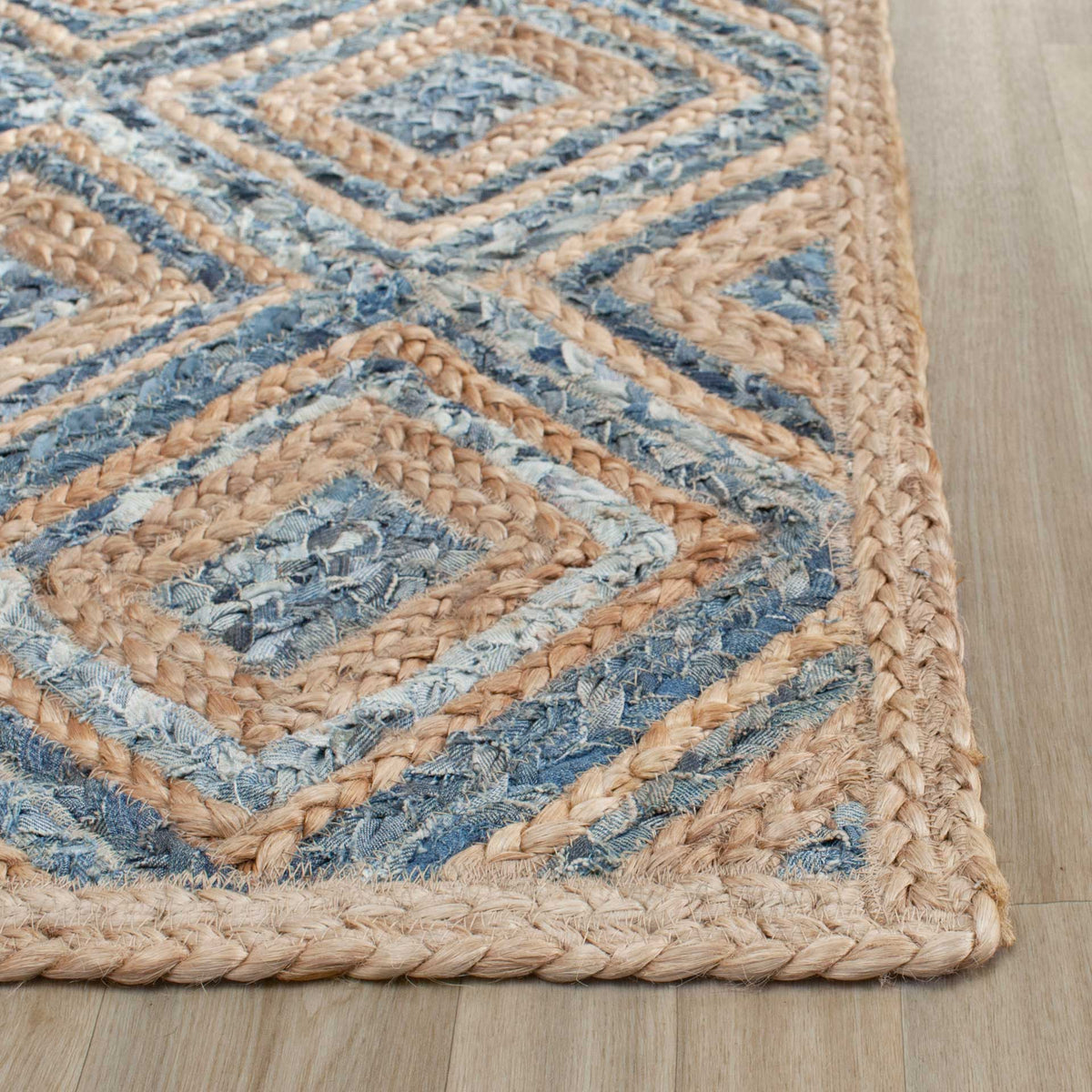 Denim-blue diamond motifs and natural jute braids frame a neatly finished edge