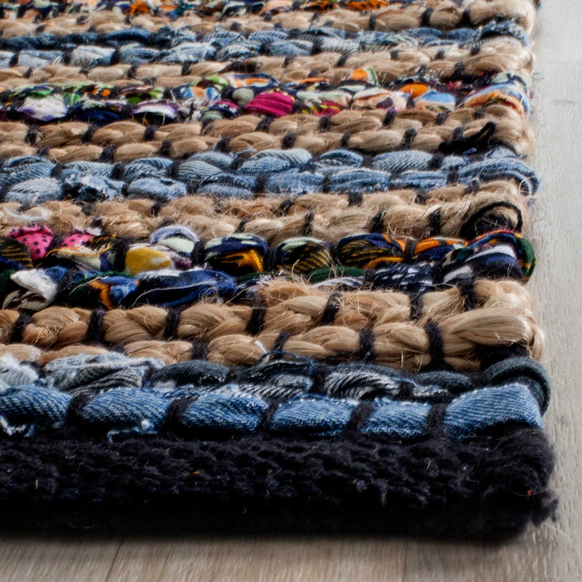 Chunky blue, tan, and vivid fabric strands form tactile stripes beside a dark woven edge