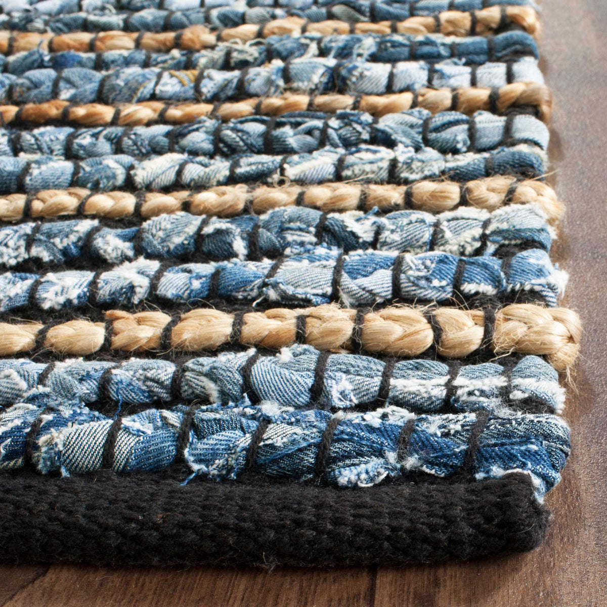Plump blue cotton loops alternate with natural jute rows above a dark woven edge
