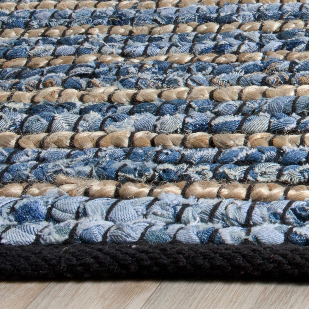 Soft blue fabric knots and tan jute fibers meet at a deep navy edge