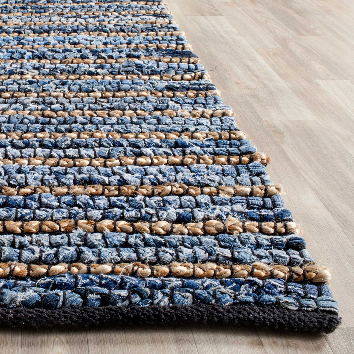 Thick blue cotton loops alternate with natural tan rows near a dark border