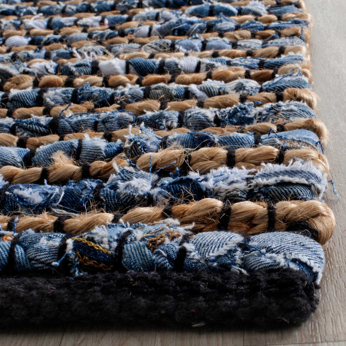 Soft blue cotton loops and natural jute knots create raised rows above a dark bound edge