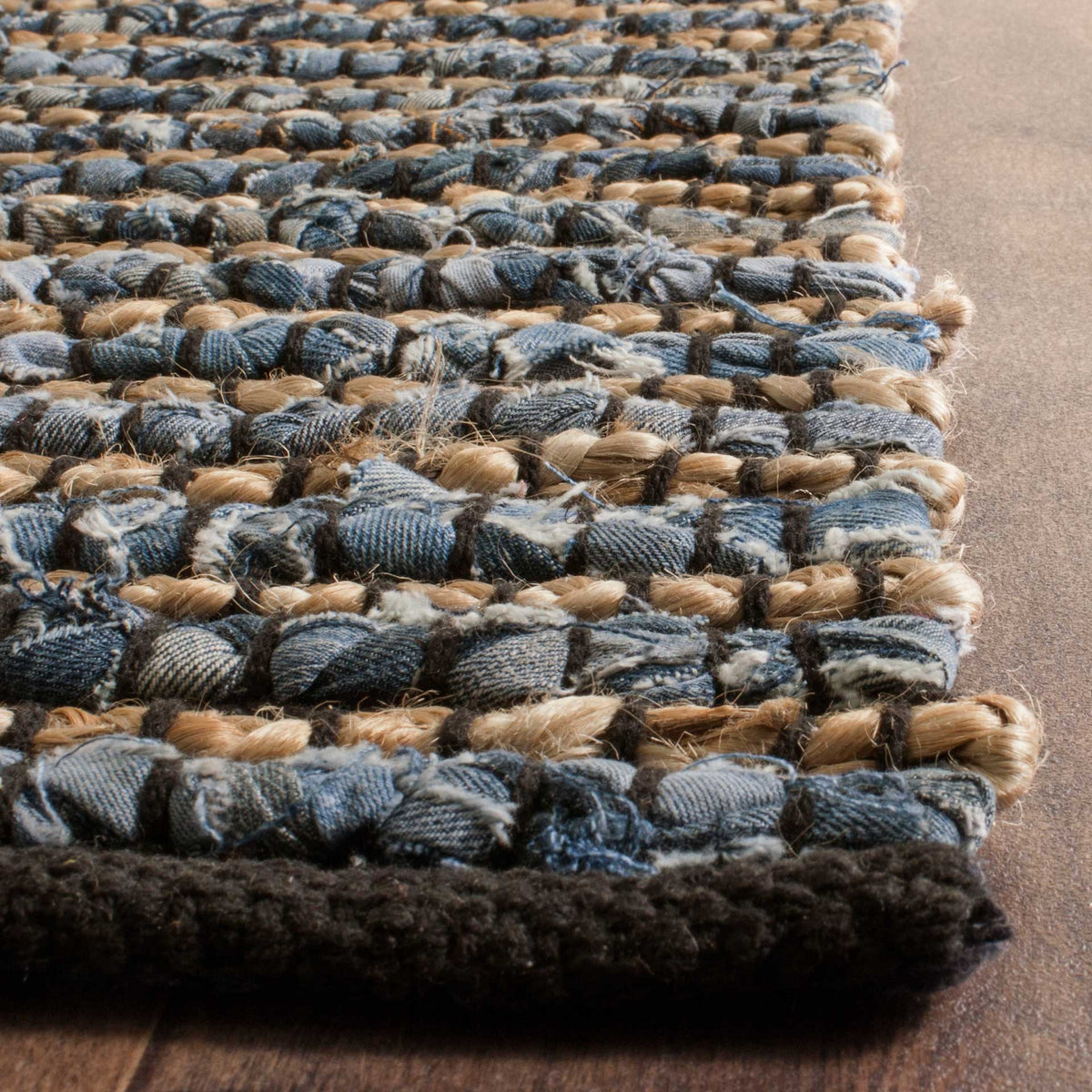Woven blue and tan knots rise above a thick, dark bound edge