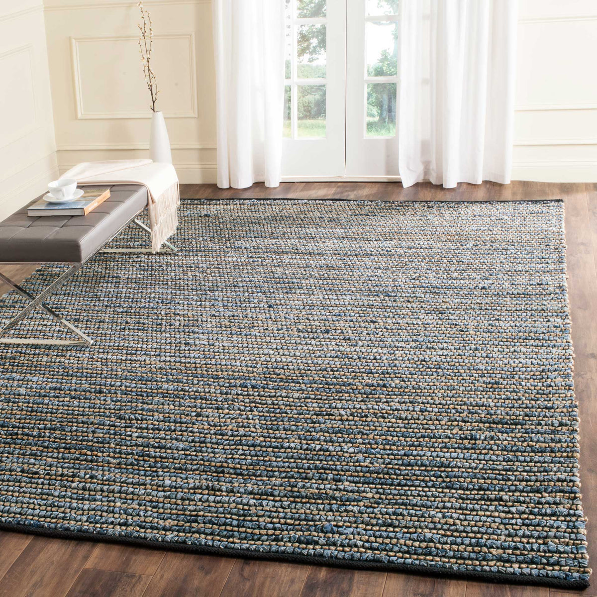 Blue and natural rows add cozy texture beside a low bench