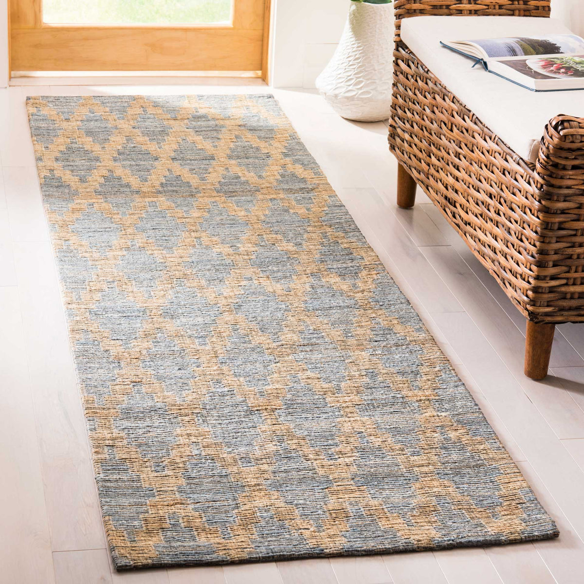 Muted blue shapes drift across a warm golden weave, bringing soft pattern to this runner