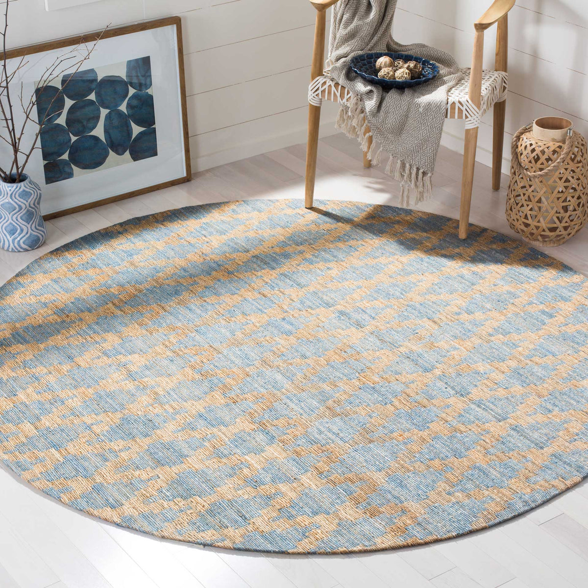Muted blue and golden tan shapes lend soft geometric rhythm to this round rug.