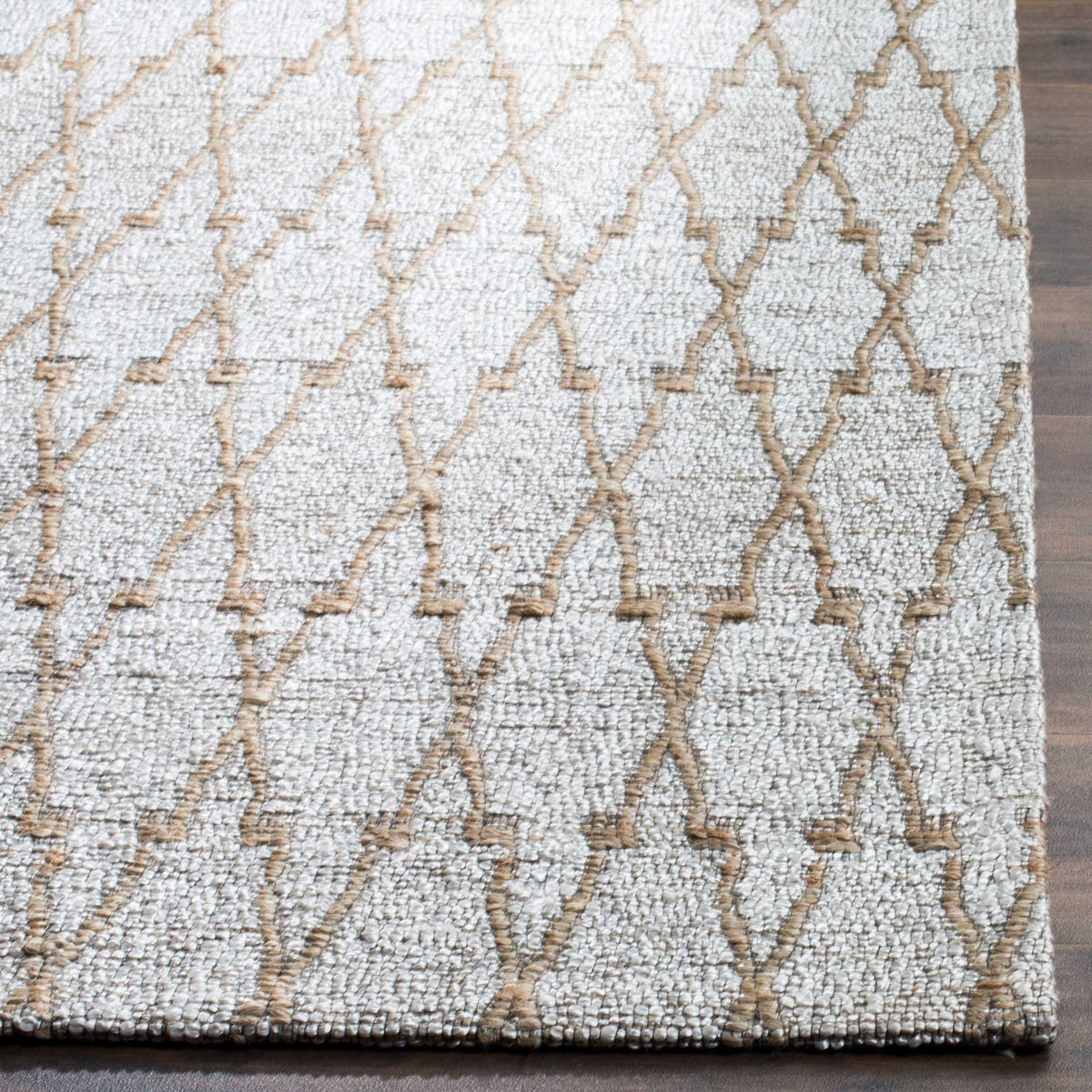 Natural tan lines form an open lattice across a pale textured rug edge
