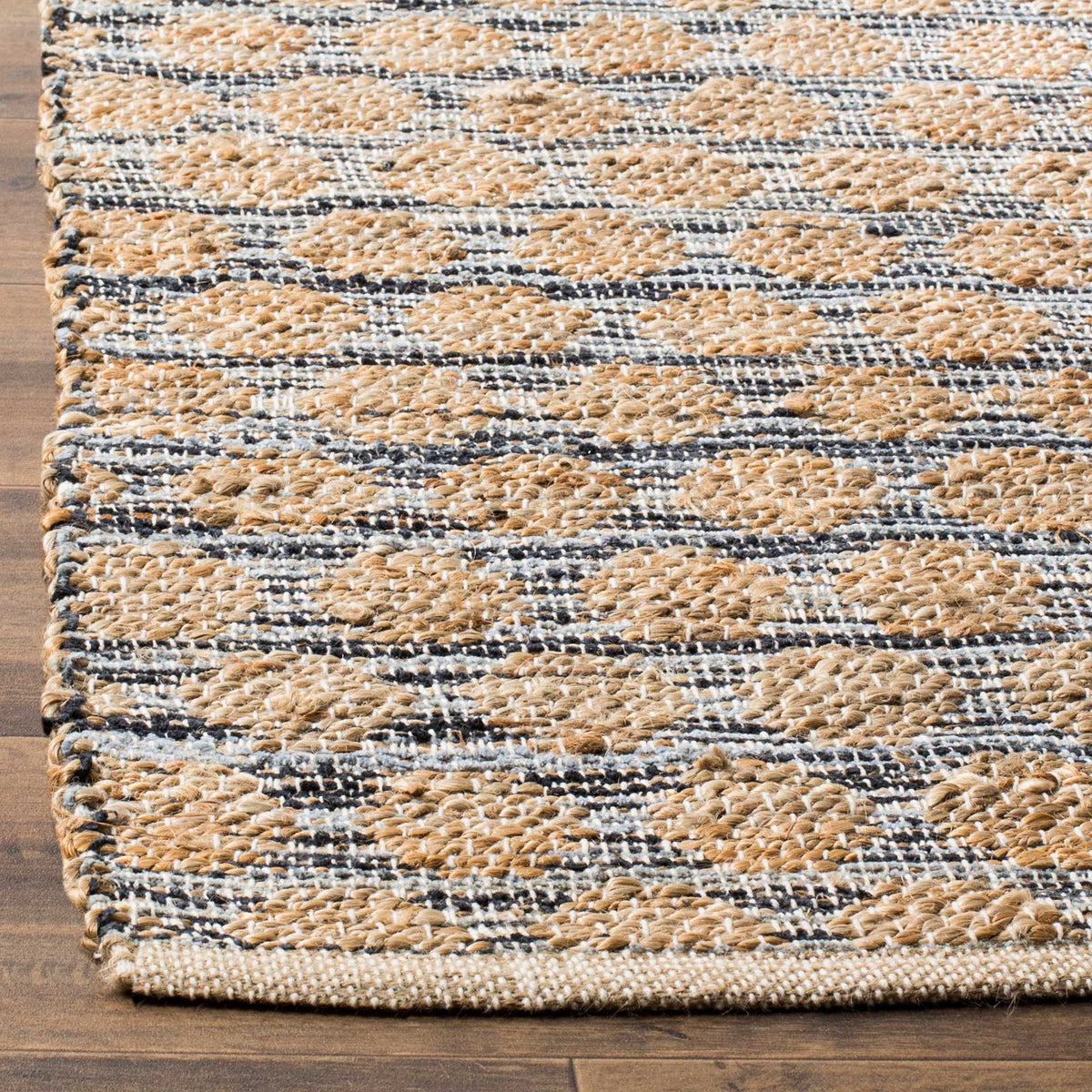 Raised natural jute loops stand out against black woven threads and a bound edge