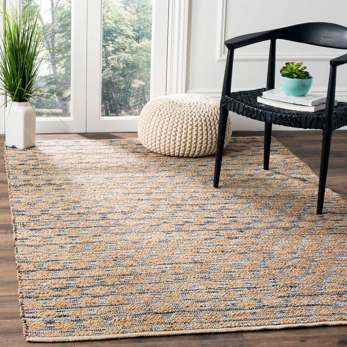 Black and natural geometric weave adds grounded texture beneath a chair