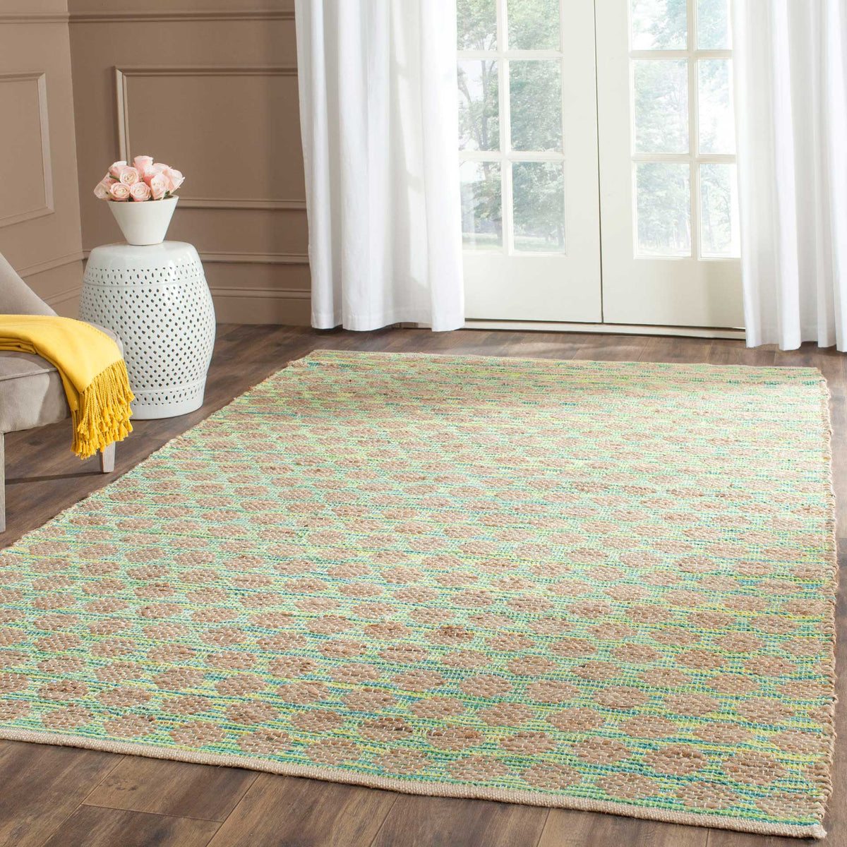 Teal geometric accents add fresh color to a natural woven rug