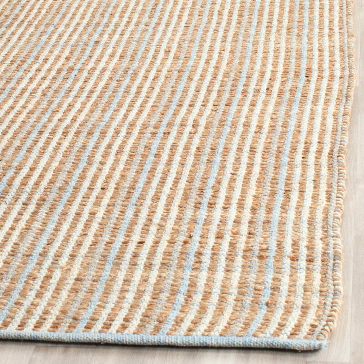 Raised natural jute cords and pale narrow stripes meet at a softly bound edge