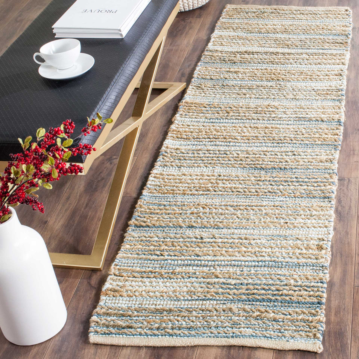 Handwoven jute and cotton runner layers soft blue stripes over warm natural fibers