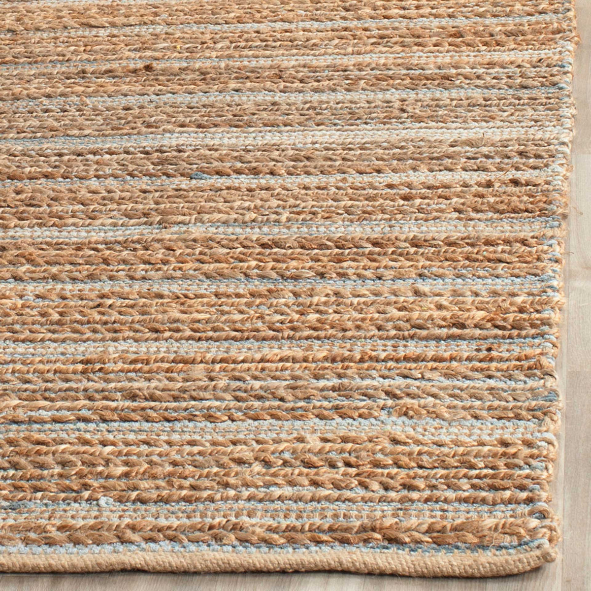 Thick jute braids and slim blue threads meet at the rug's reinforced edge