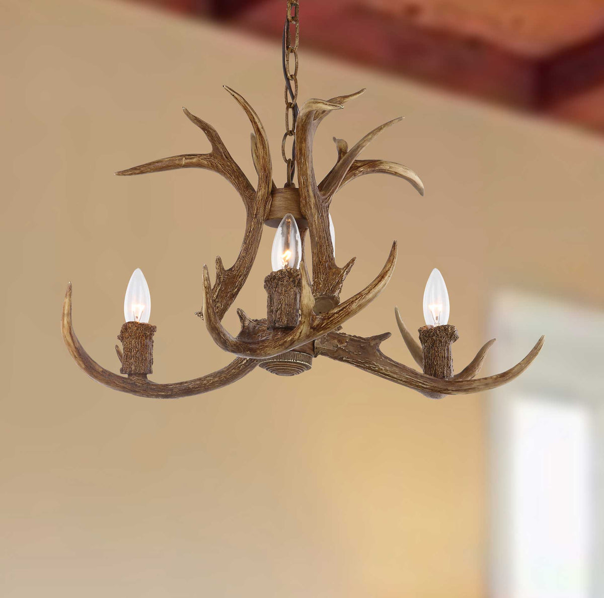 Glowing candle-style bulbs add warmth to a chandelier of sweeping brown antlers