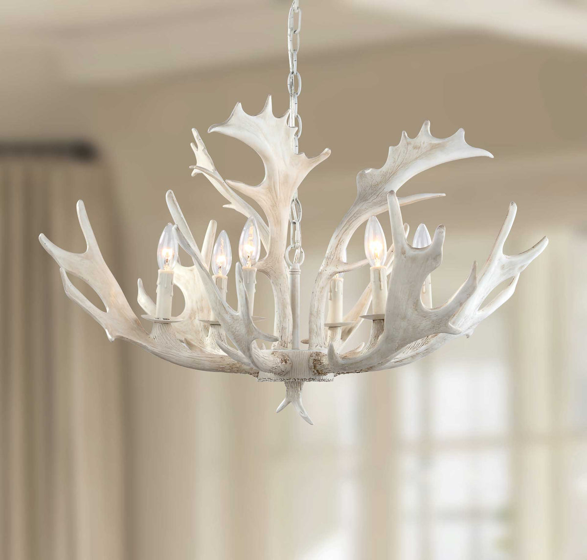 Warm light glows amid branching white antlers for an inviting ambiance.