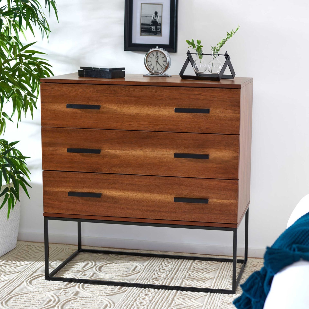 Warm brown drawers and sleek black accents bring modern storage to a living space