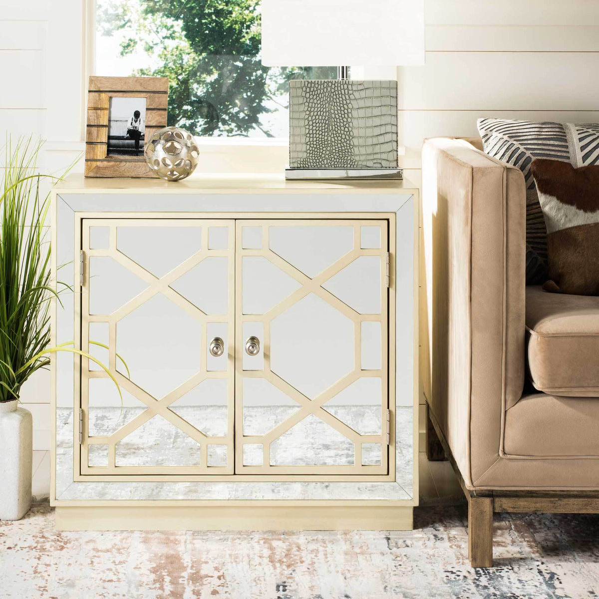 Antique beige latticework and mirror-paneled doors create an elegant accent beside a sofa.