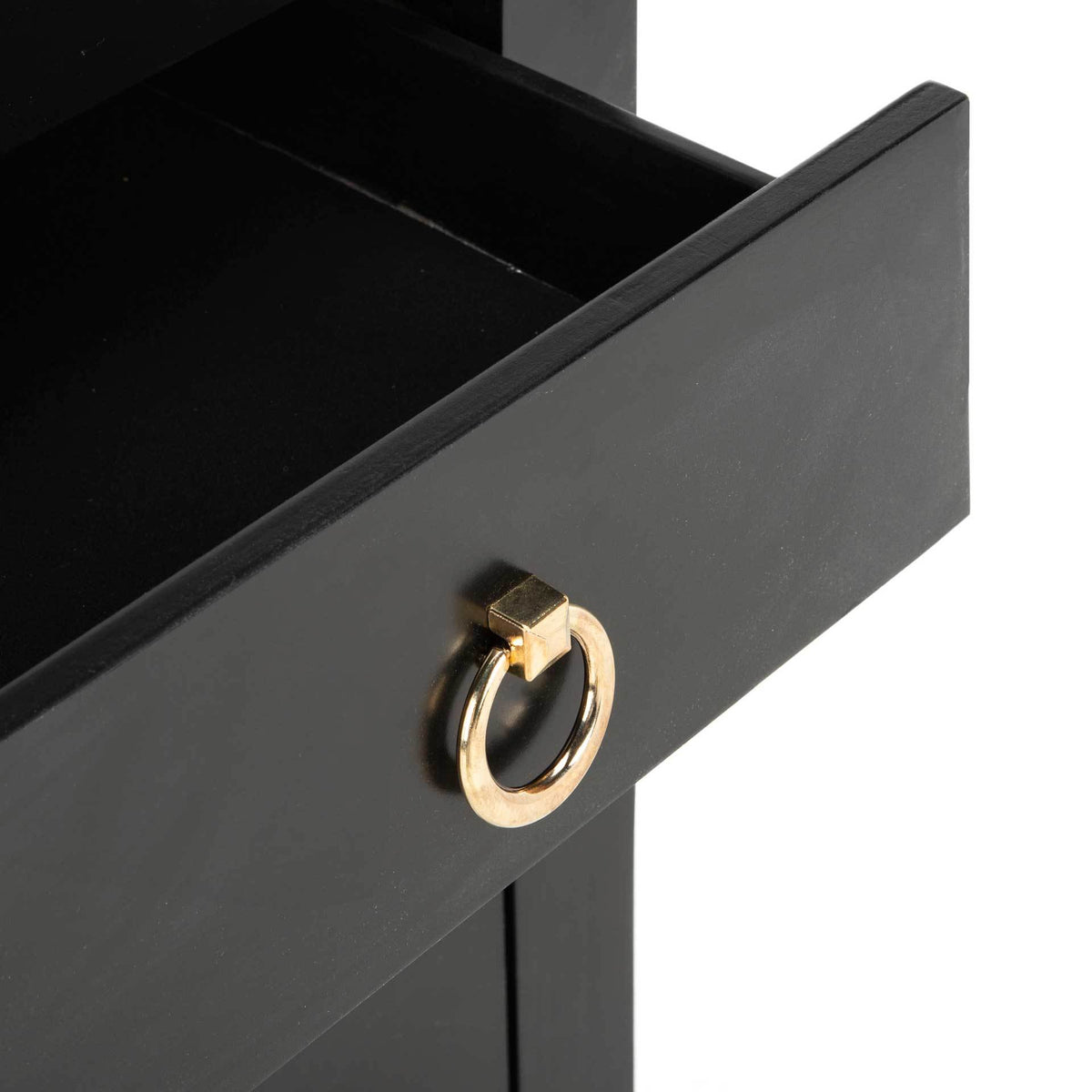 Open black drawer reveals a dark interior and a gleaming gold ring pull