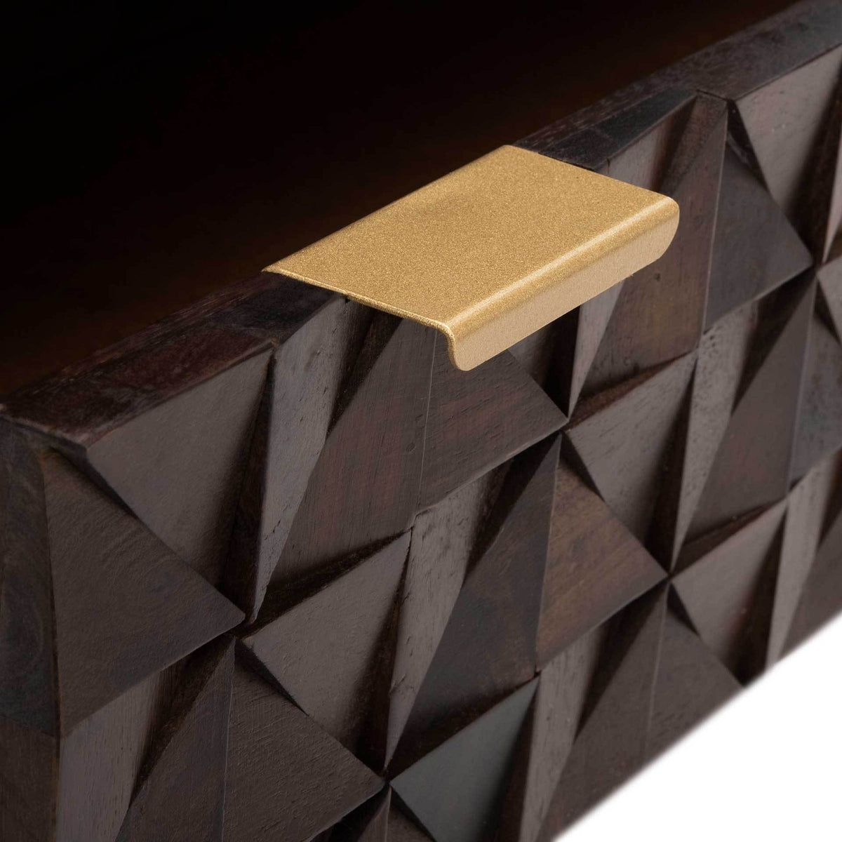 A slim brass pull adds a warm gleam against the dark, faceted wood.