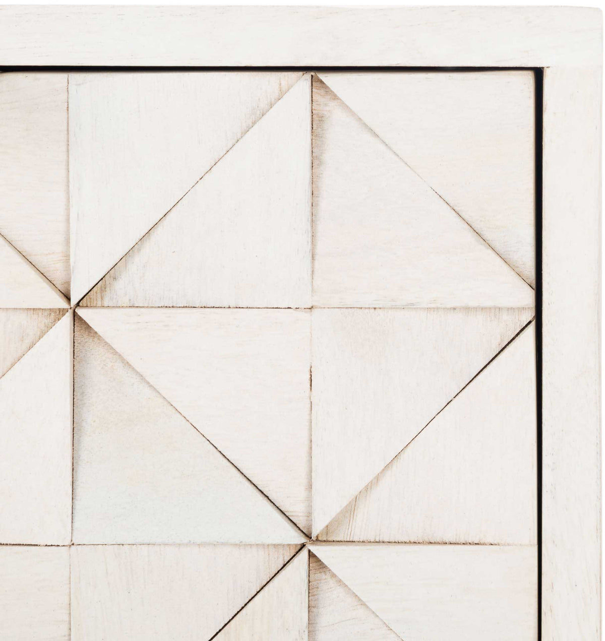 Carved triangles create subtle depth across the softly whitewashed drawer fronts.