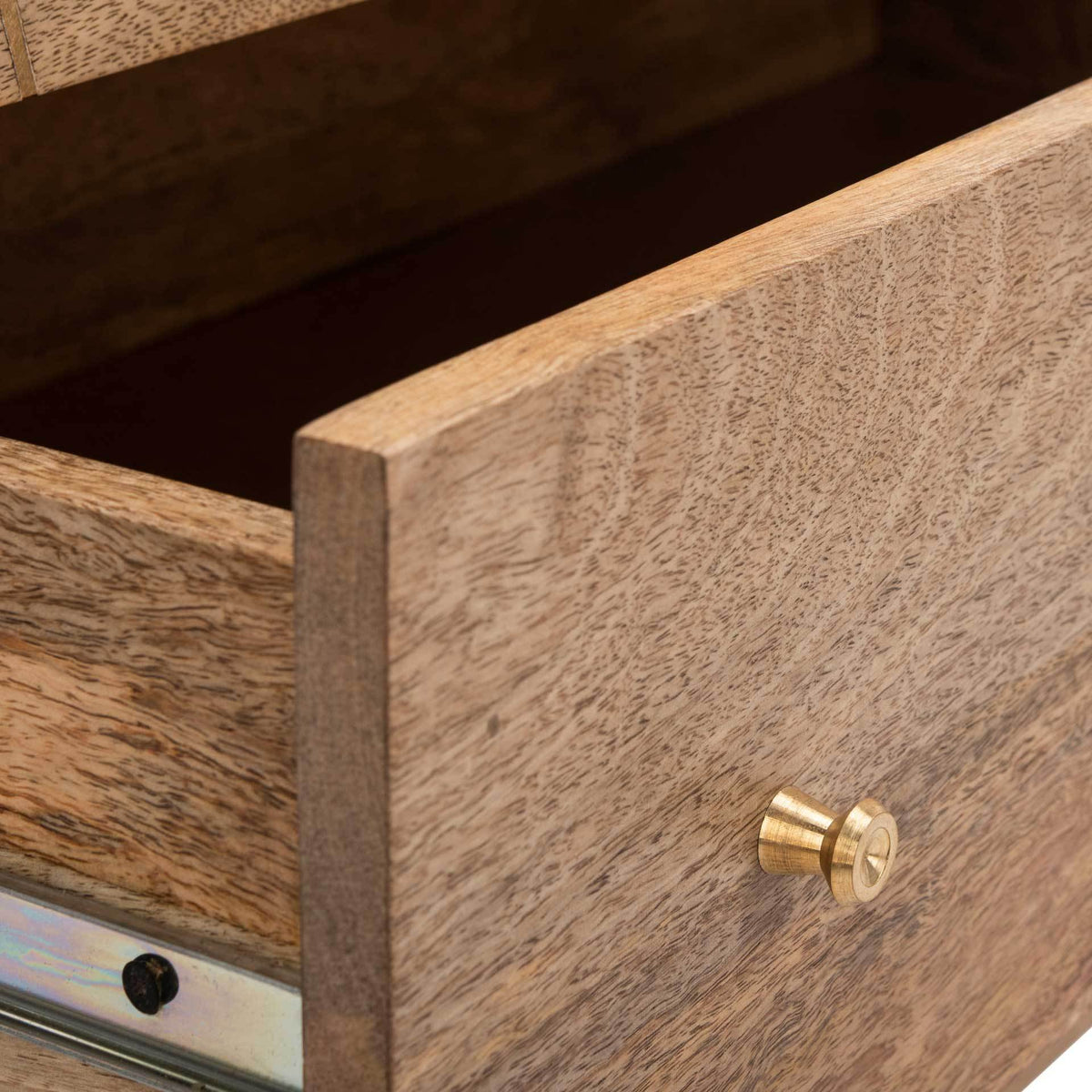 An open wood drawer reveals its storage compartment, metal glides, and a small brass knob.