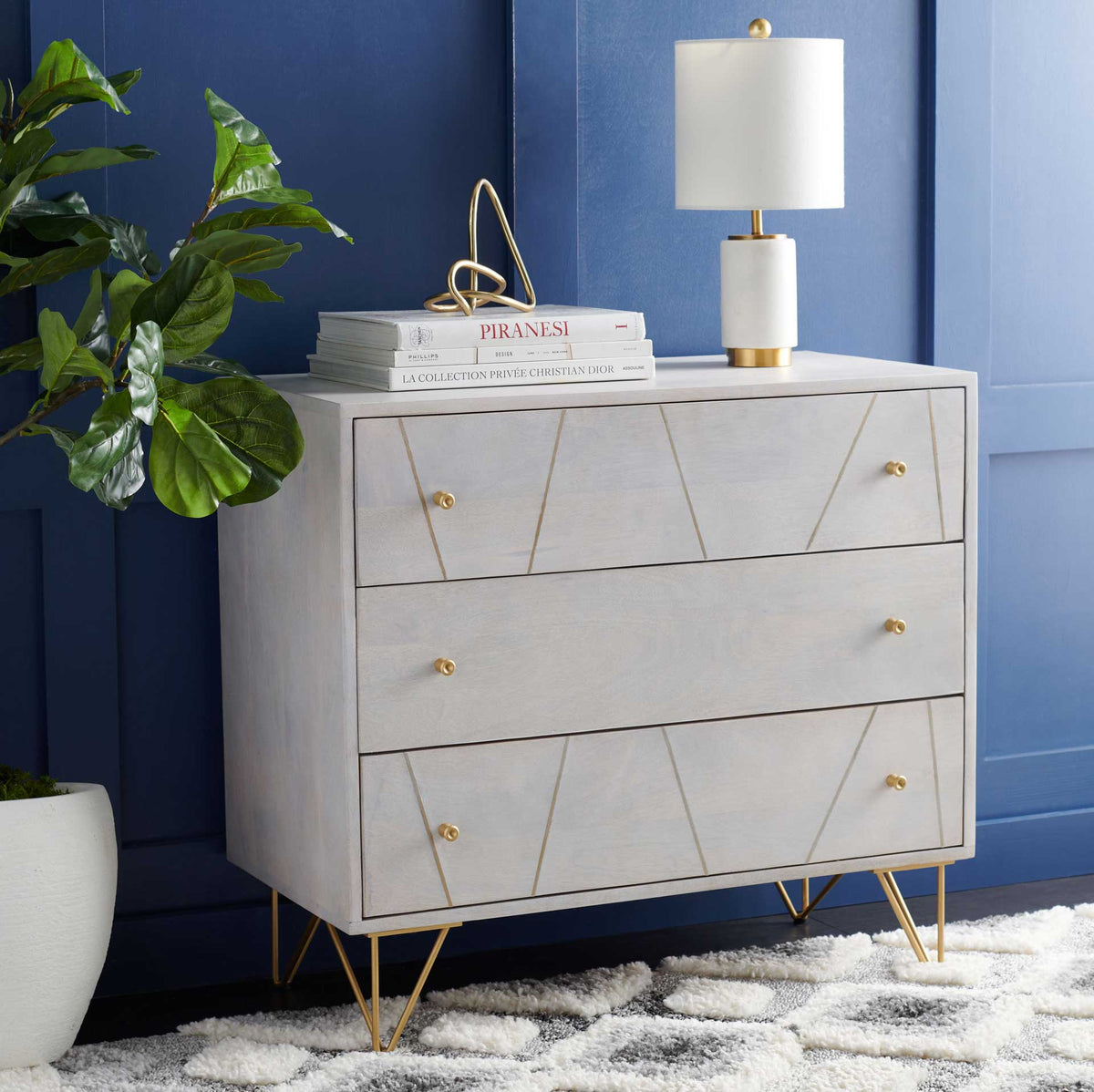 Whitewashed drawers and brass hairpin legs provide bright storage with an airy profile.