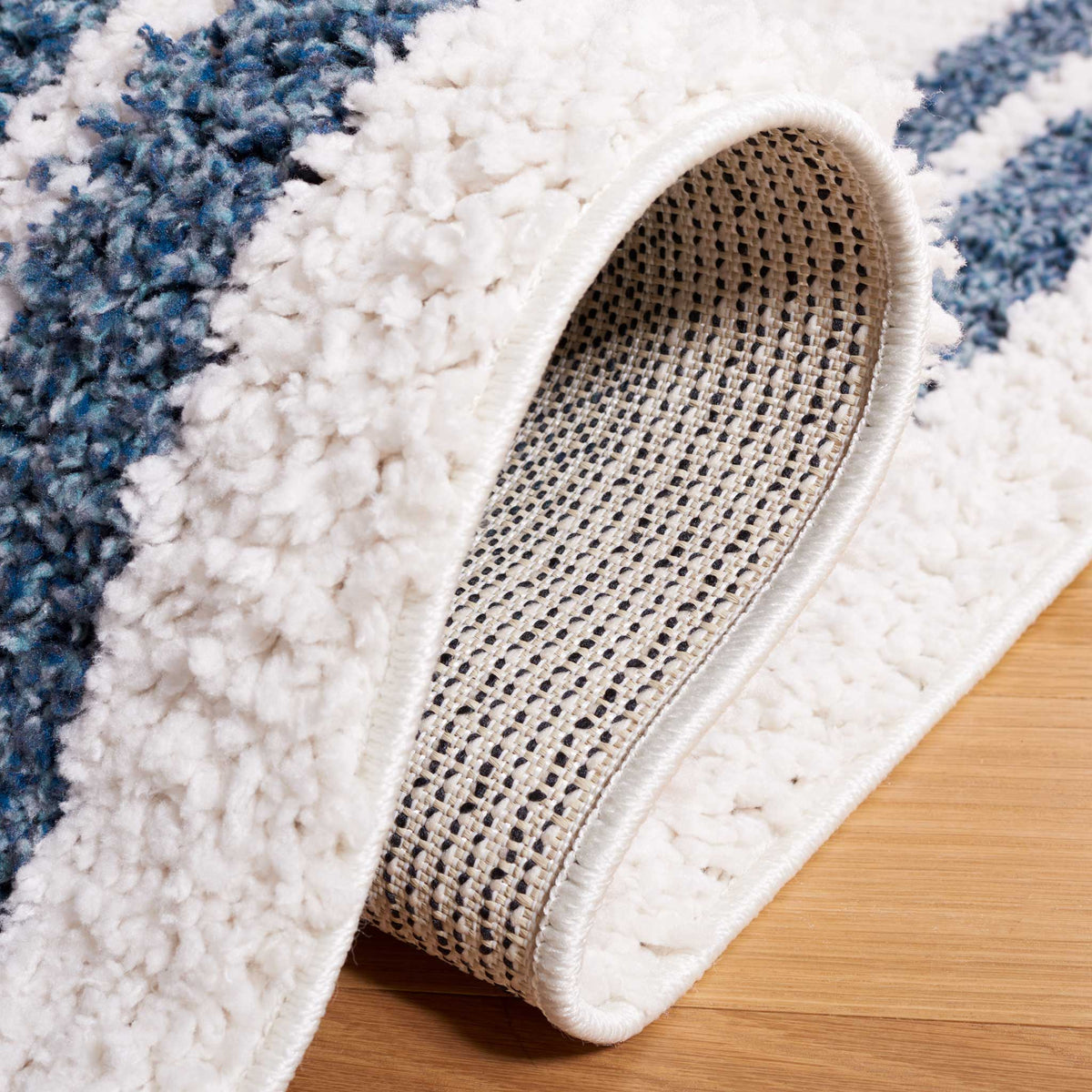 Plush ivory fibers curl back to expose a tightly woven backing